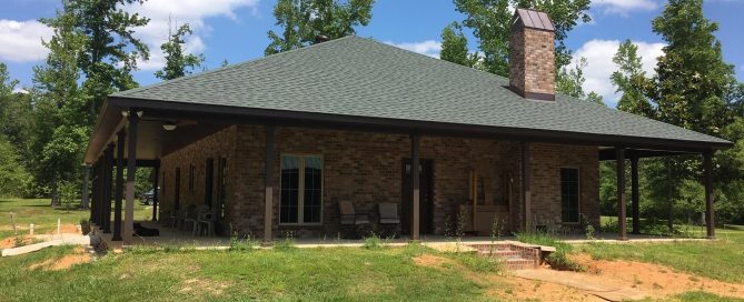 acadian style brick home w copper chimney cover highlight