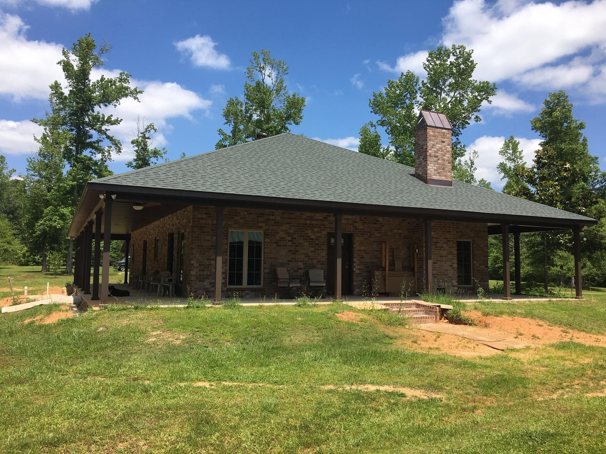 acadian style brick home w copper chimney cover highlight
